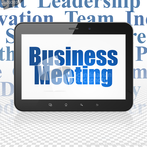 Image of Finance concept: Tablet Computer with Business Meeting on display