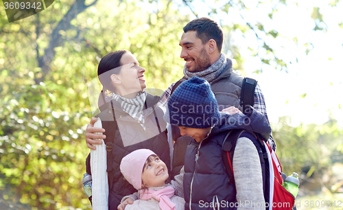Image of happy family with backpacks hiking