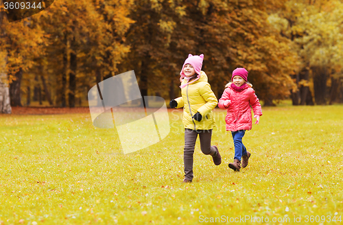 Image of group of happy little girls running outdoors