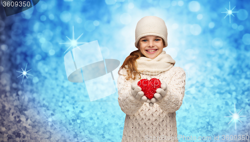 Image of girl in winter clothes with small red heart