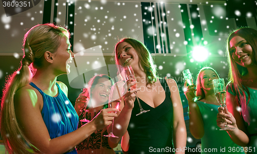 Image of young women with glasses of champagne in club