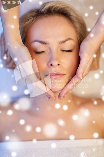 Image of close up of woman having face massage in spa salon