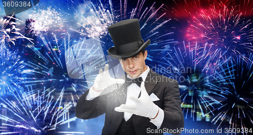 Image of magician in top hat showing trick