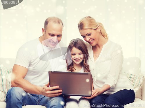 Image of smiling family with laptop at home