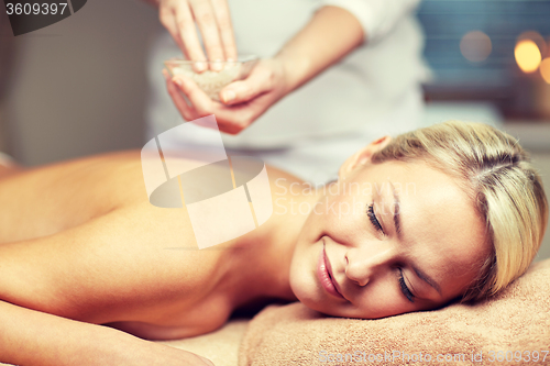 Image of close up of woman lying and having massage in spa