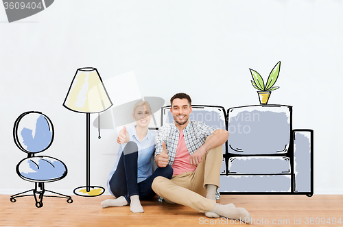 Image of happy couple showing thumbs up at new home