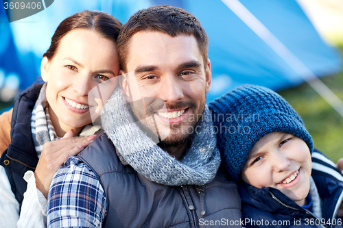 Image of happy family with tent at camp site