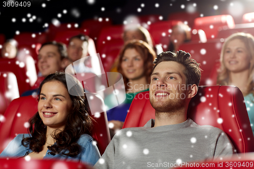 Image of happy friends watching movie in theater