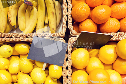 Image of fruits in baskets with nameplates at food market