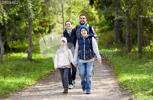 Image of happy family with backpacks hiking