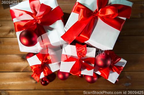 Image of close up of gift boxes and red christmas balls