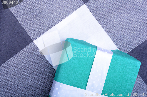 Image of holiday Green gift box with white ribbon