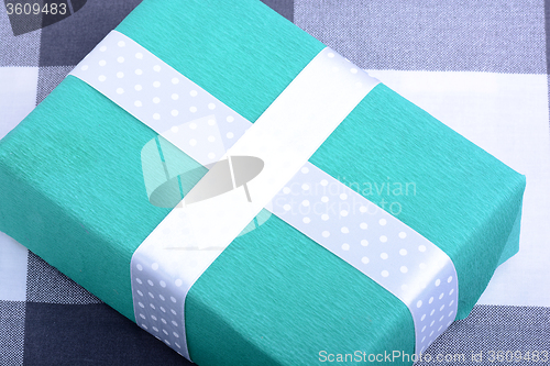 Image of holiday Green gift box with white ribbon