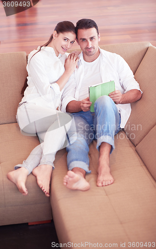 Image of couple at modern home using tablet computer