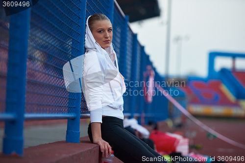 Image of sporty woman on athletic race track