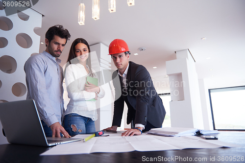 Image of couple buying new home with real estate agent