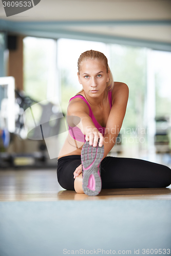 Image of woman stretching and warming up for her training at a gym