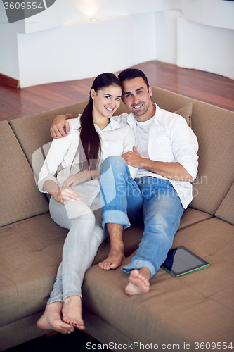 Image of couple at modern home using tablet computer
