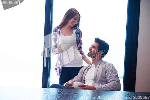 Image of relaxet young couple drink first morning coffee