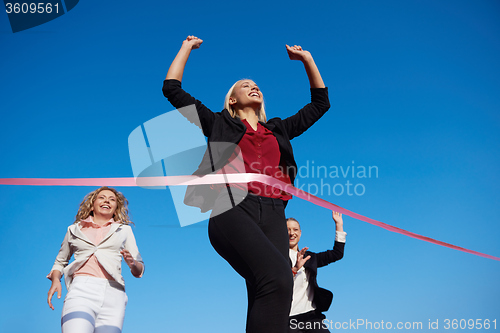 Image of business people running on racing track