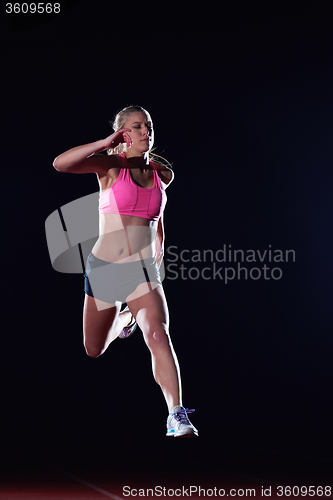 Image of Athletic woman running on track