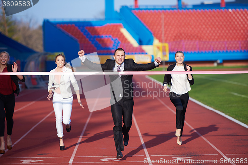 Image of business people running on racing track