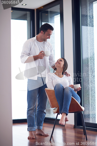 Image of relaxet young couple drink first morning coffee