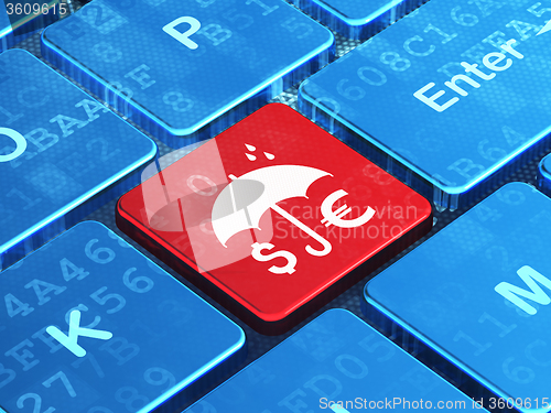 Image of Protection concept: Money And Umbrella on computer keyboard background