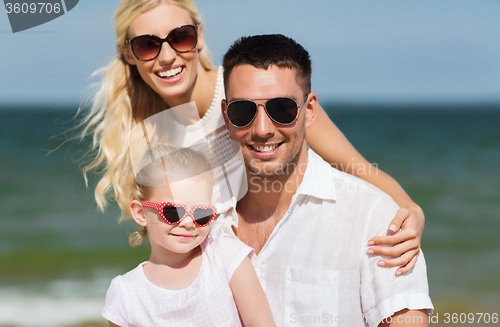 Image of happy family in sunglasses on summer beach