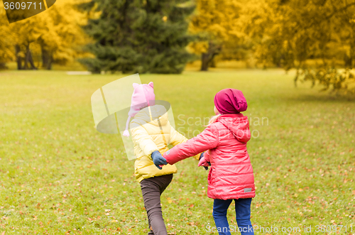 Image of happy little girls running outdoors