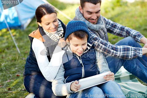 Image of happy family with tablet pc and tent at camp site