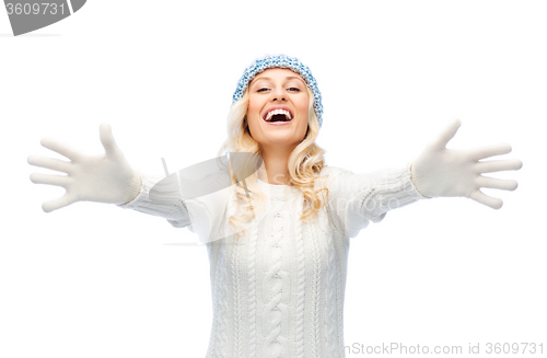 Image of smiling young woman in winter hat and sweater