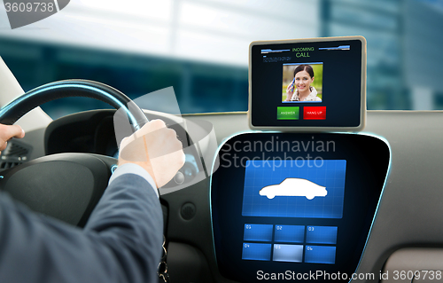 Image of close up of man driving car and receiving call