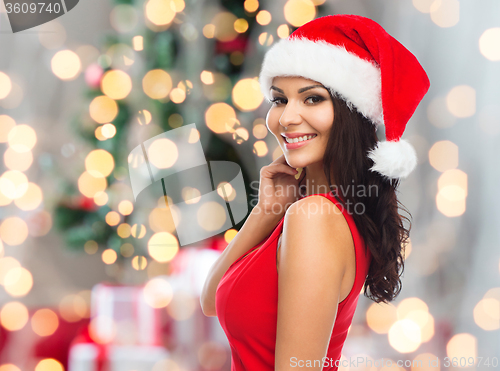 Image of beautiful sexy woman in santa hat and red dress