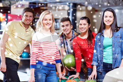 Image of happy friends in bowling club at winter season