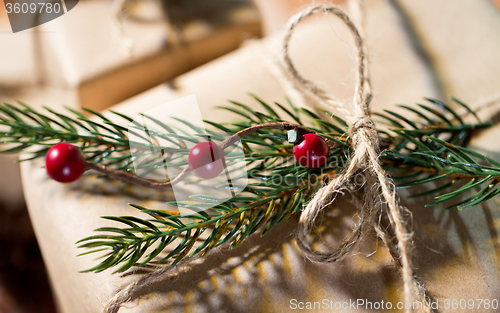 Image of close up of christmas gift with fir brunch