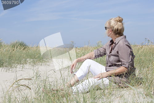 Image of Vacationer sitting on the beach