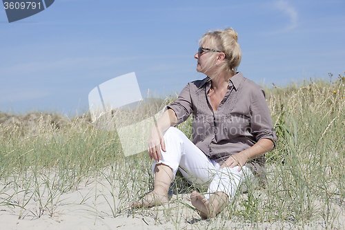 Image of Vacationer sitting in the dunes