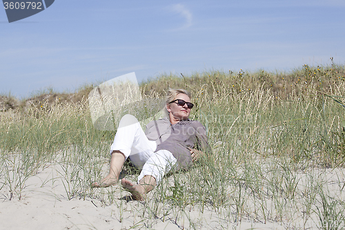 Image of Vacationer relaxed in the dunes