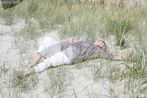 Image of Vacationer lying in the dunes