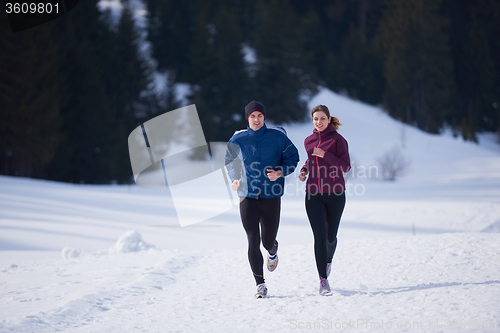 Image of couple jogging outside on snow