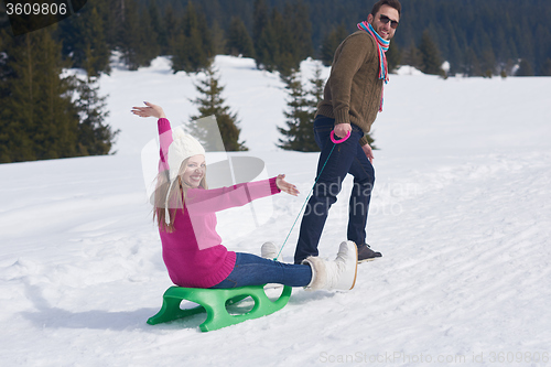 Image of happy young couple having fun on fresh show on winter vacation