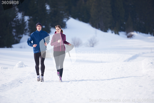 Image of couple jogging outside on snow