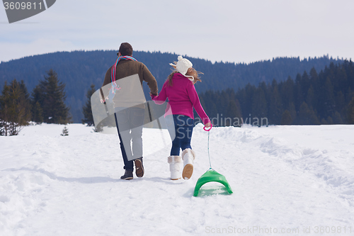 Image of happy young couple having fun on fresh show on winter vacation