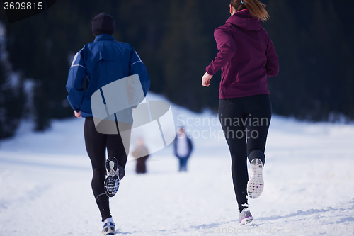 Image of couple jogging outside on snow