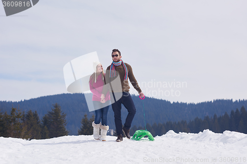 Image of happy young couple having fun on fresh show on winter vacation