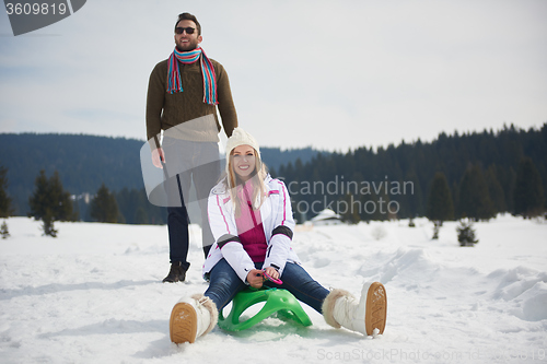 Image of happy young couple having fun on fresh show on winter vacation