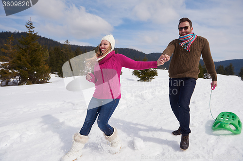 Image of happy young couple having fun on fresh show on winter vacation