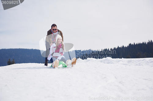 Image of happy young couple having fun on fresh show on winter vacation