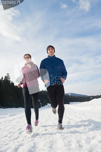 Image of couple jogging outside on snow